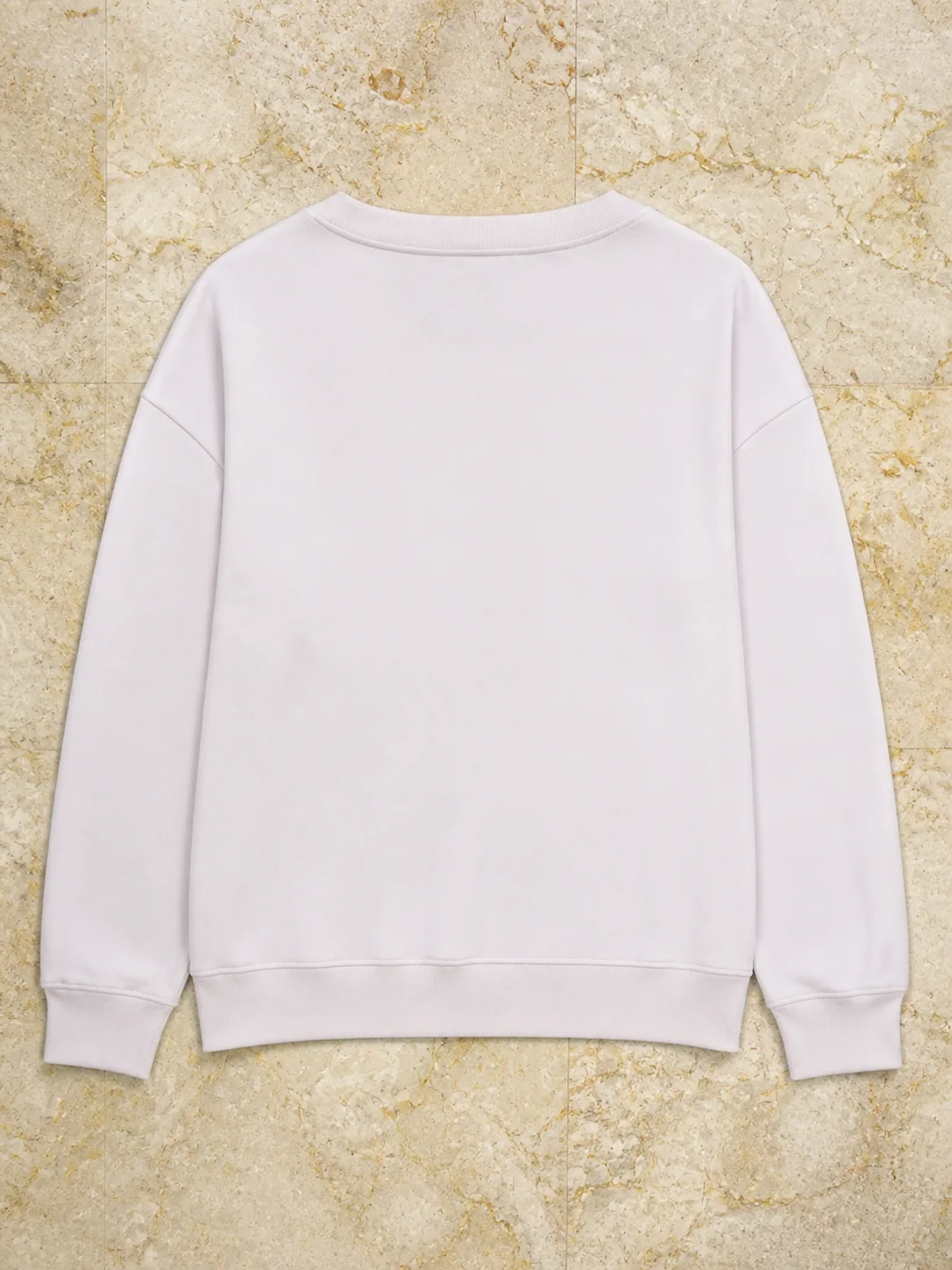 Back of a plain white custom sweatshirt on marble