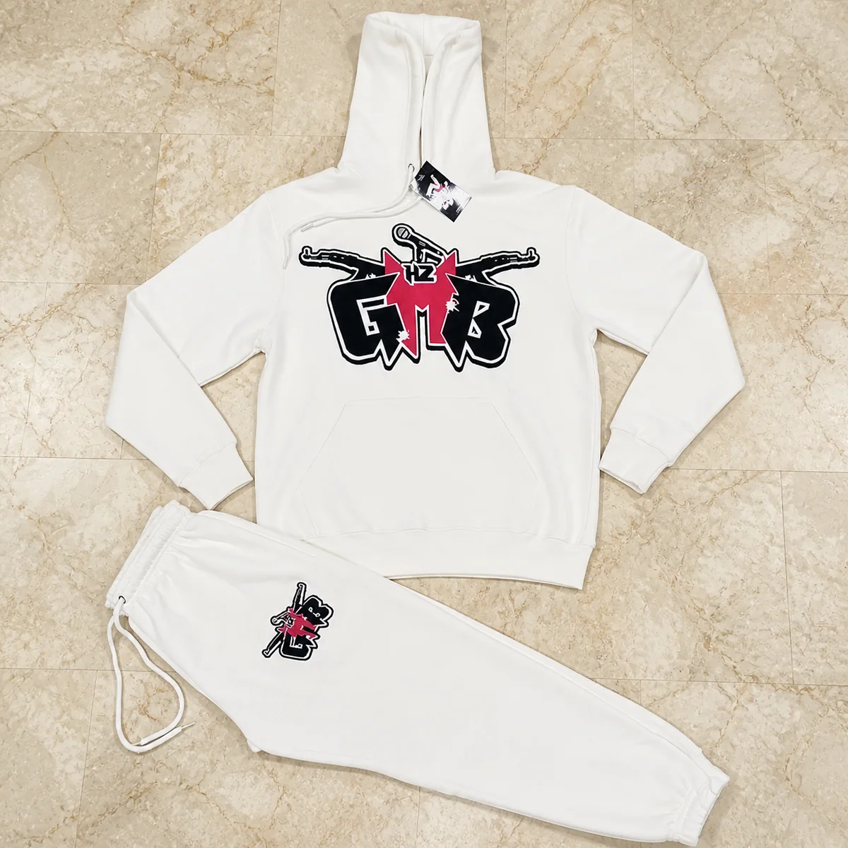 White printed hoodie and sweatpants set on marble