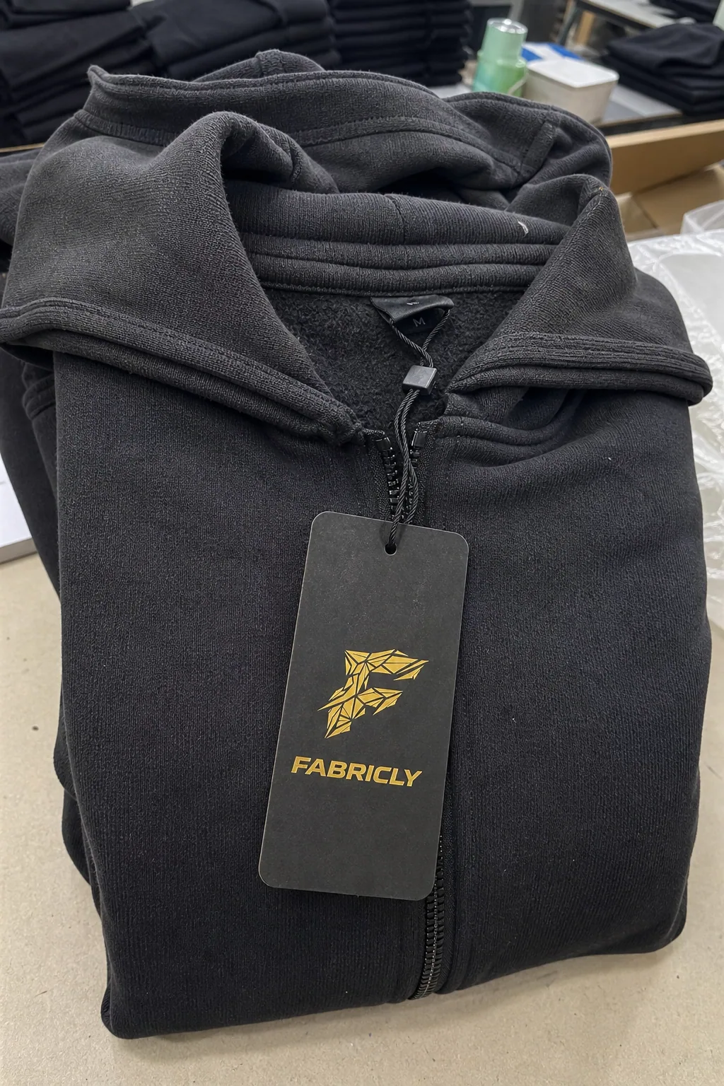 Custom Fabricly hang tag attached to a finished heavyweight hoodie