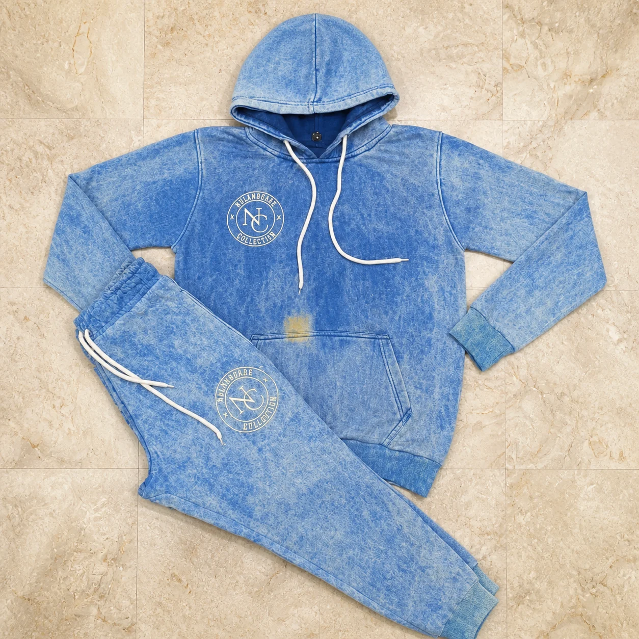 Blue acid-wash hoodie and jogger set with embroidered brand marks