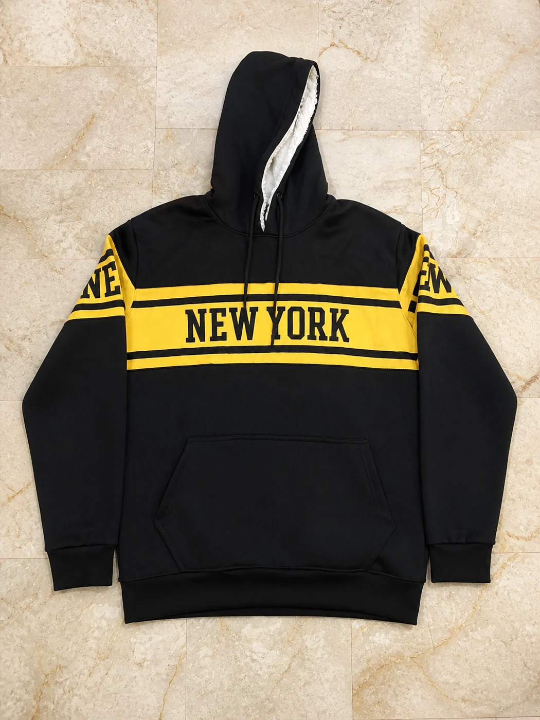 Black and yellow color-block hoodie with New York lettering and a white sherpa-lined hood