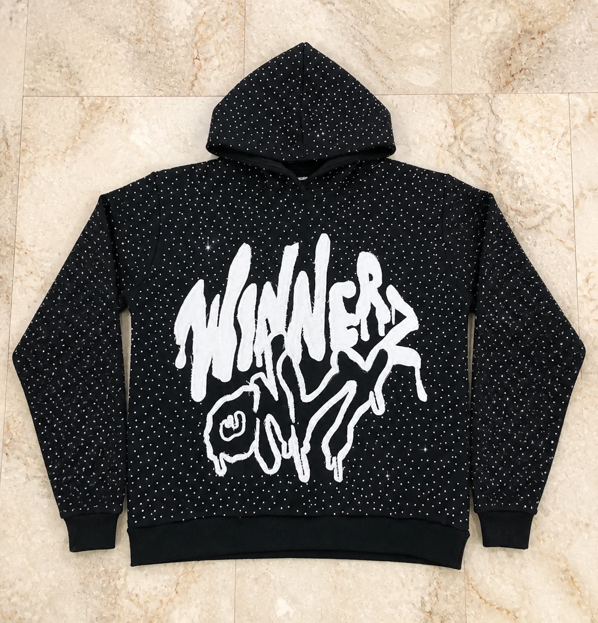 Black statement hoodie covered with rhinestones and a white graphic